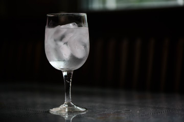 Drinking water and ice in wine glass on dining  table