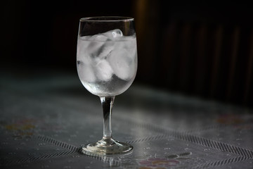 Drinking water and ice in wine glass on dining  table