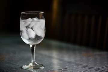 Drinking water and ice in wine glass on dining  table