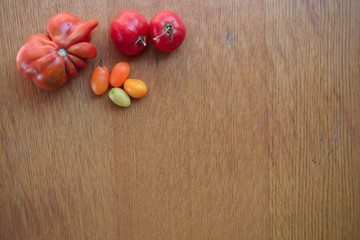 Tomatoes on a wooden background. Top view. Free space for text.