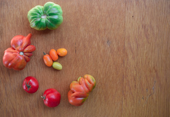 Tomatoes on a wooden background. Top view. Free space for text.