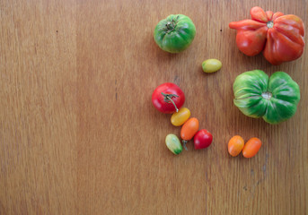 Tomatoes on a wooden background. Top view. Free space for text.