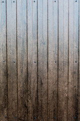 Brown wooden wall or fence background. Backdrop with vertical wooden planks. Copyspace for text