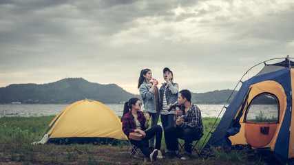 Fototapeta na wymiar Group of backpackers relaxing near campfire, tourist background.