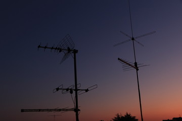 two antenna tv on a roof on a blue and pink sky background, sunset, sunrise, antennas silhouette