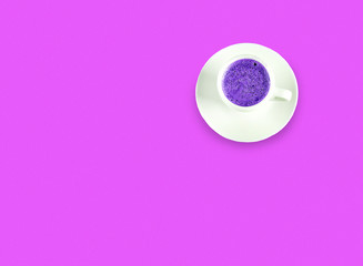 Cardboard cup of coffee on  neon background, copy space, top view