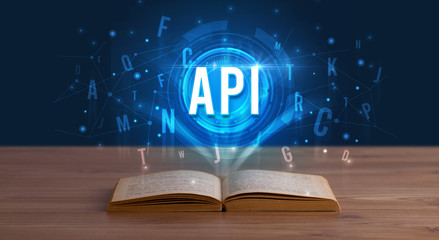 API inscription coming out from an open book, digital technology concept