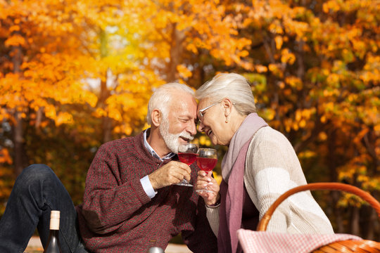 Romantic couple with wine outdoors.