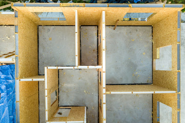 Construction of new and modern modular house. Walls made from composite wooden sip panels with styrofoam insulation inside. Building new frame of energy efficient home concept.