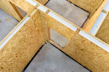 Construction of new and modern modular house. Walls made from composite wooden sip panels with styrofoam insulation inside. Building new frame of energy efficient home concept.