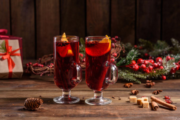 Christmas hot mulled wine with cinnamon cardamom and anise on wooden background