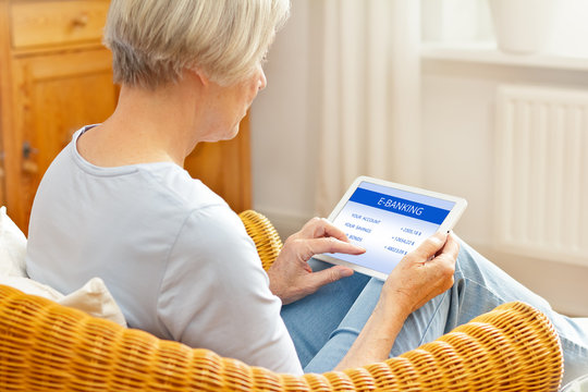 Senior People And Online Banking Concept, Elderly Woman With Tablet Computer At Home, Touching Screen