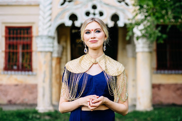 Close -up portrait european blond girl in asian or indian traditional dress with nice earrings on...