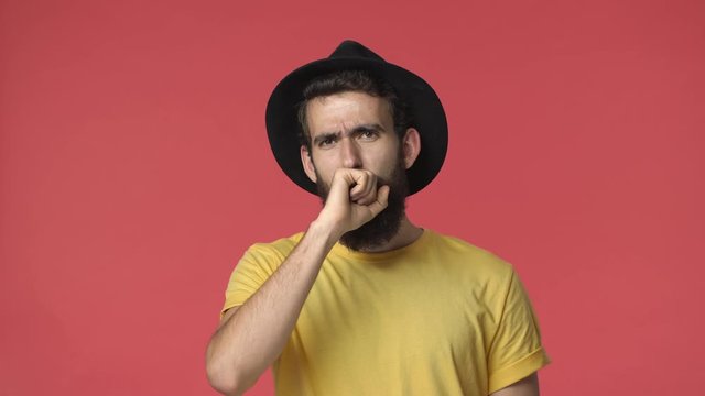Ouch thats rough. Handsome upset bearded middle-eastern guy in black hat, yellow t-shirt stare surprised react disappointed, shaking head, see something painful, cringe from friend got roasted