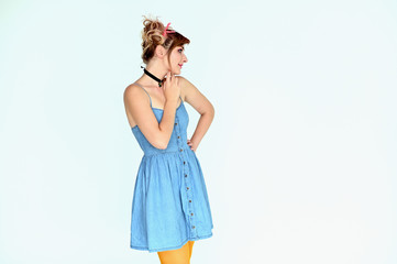 Portrait of a cute happy funny blonde girl with colored hair in a funny dress on a white background. Smiling in various poses, beauty, holiday.