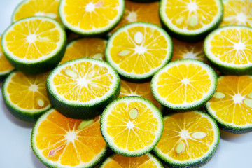 Fototapeta na wymiar round slices of natural fresh tangerines, oranges, lemon, lime with green peel