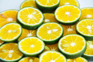 Fototapeta premium round slices of natural fresh tangerines, oranges, lemon, lime with green peel