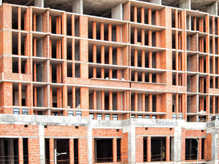 Brick wall with columns of a new unfinished building