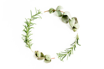 Round wreath frame made of mix of herbs, green branches, leaves  eucalyptus, rosemary and plants...