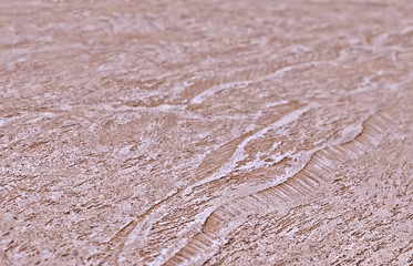Side view of a modern decorative pink textured stucco with shallow depth of field. Modern creative trendy background.