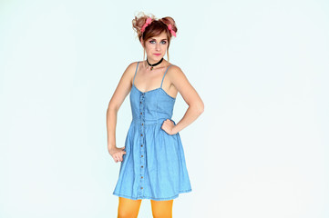 Portrait of a cute happy funny blonde girl with colored hair in a funny dress on a white background. Smiling in various poses, beauty, holiday.