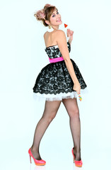 Full-length vertical portrait of a cute happy funny blonde girl with colored hair in a cheerful dress on a white background with candy in her hands. Smiling in various poses, beauty, holiday.