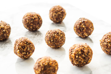 Energy protein balls with healthy ingredients on marble table. Home made with dates, peanut butter, flax and chia seeds, oats, almond and chocolate drops. Food modern pattern on marble table - 289097538
