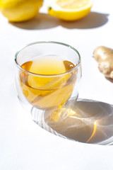 Glass of green tea with lemon and ginger close up