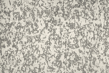 Beautiful textured wall with decorative beige stucco with scuffs and cracks. Modern texture trendy abstract background