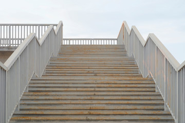 Naklejka premium Metal rusty stairs painted in grey going up.