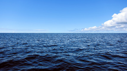 Calm blue sea and white clouds on a beautiful sunny day. Baltic Sea, Finland.