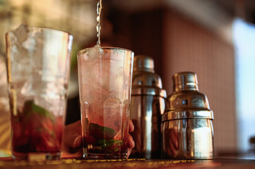 Barman making cocktail.Barman hand squeezing fresh juice to serve .