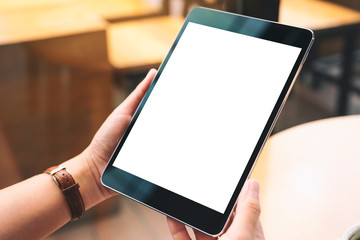 Mockup image of hands holding black tablet pc with blank white desktop screen