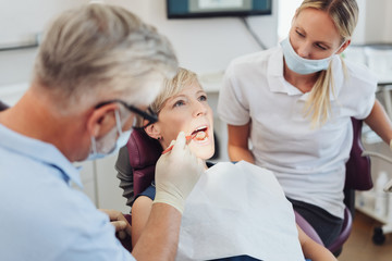 Fototapeta na wymiar Male dentist examining the teeth of a woman