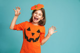 little girl in pumpkin costume
