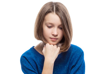 A cute teenager girl in a blue sweater thought, propping her head on her hand. Isolated over white background.