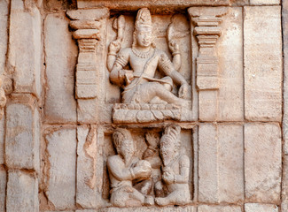 Indian art on facade of temple with Shiva Lord and ancient hindu people. South Indian landmark, the...