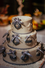 White decorated cake with three layers ribbons