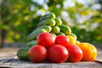 cucumbers and tomatoes on the wooden table