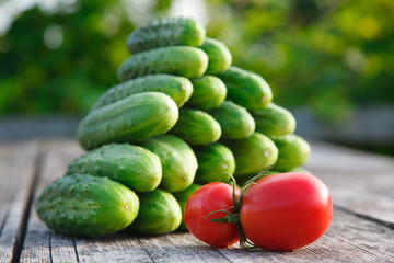 cucumbers and tomatoes on the wooden table