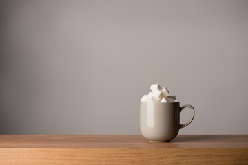 Ceramic Coffee Mug Filled with Sugar Cubes, Copy Space