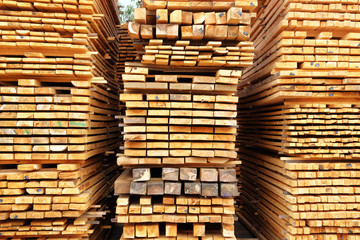 Stack of wooden bars. Pile of new wooden boards on a storage.