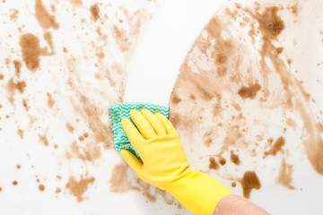 Gloved Hand Wiping Clean a Messy Counter with a Cloth