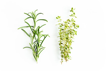 Obraz premium Green branchs of rosemary, thyme isolated on a white background. Flat lay. Top view