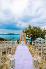 Looking down the aisle to a wedding altar with the seas behind