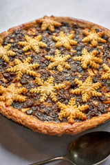 Whole Mince Pie with Snowflake-Shaped Decoration and a Spoon