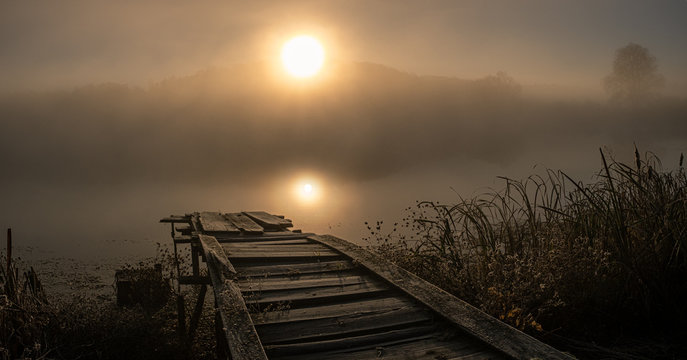 Lake pier on the foggy morning © panafoto