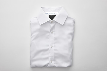 top view of plain folded shirt on white background