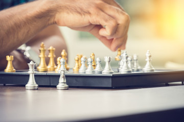 Casual businessman playing chess game with retro style photo, in business competition and planning strategies concept.