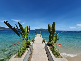 Beach in Nhatrang island, Vietnam. Sunny day at the sea with blue sky, summer vacation in southeast Asia.